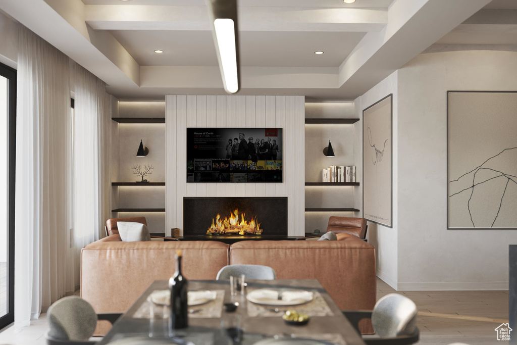 Dining room featuring wood finished floors and a lit fireplace