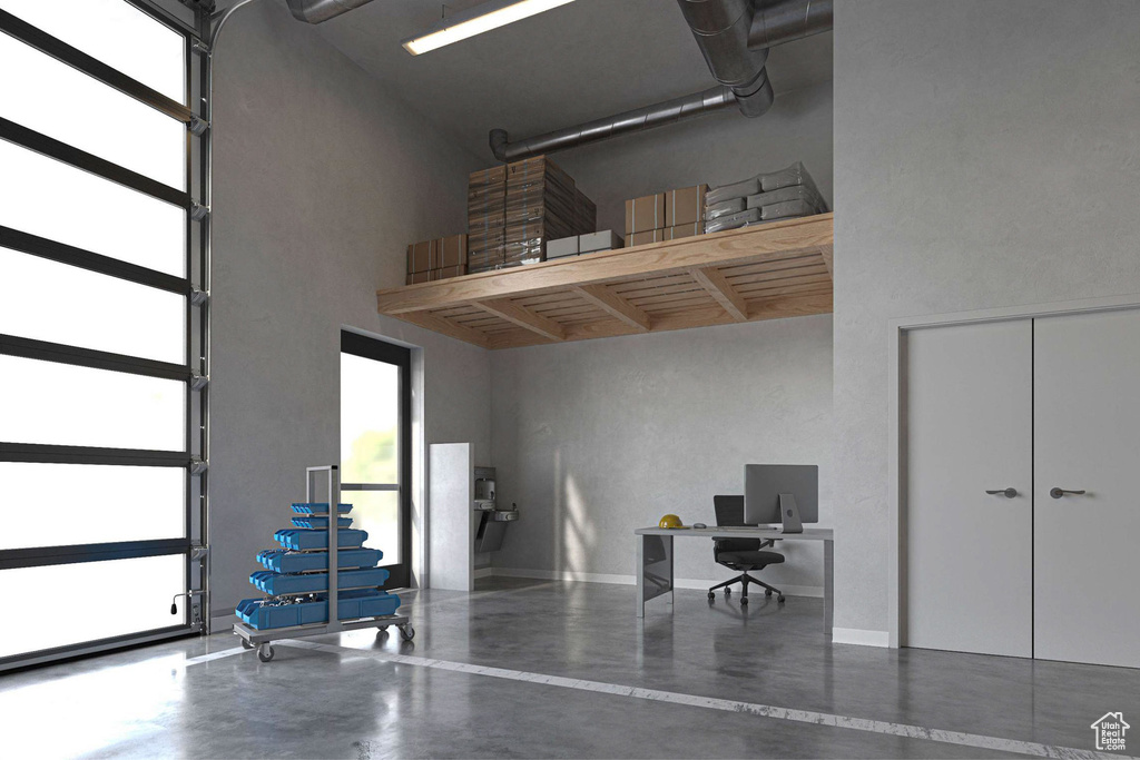 Garage with a desk and baseboards