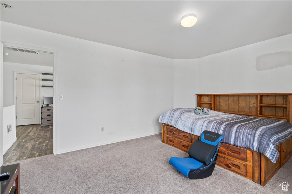 Carpeted bedroom featuring baseboards