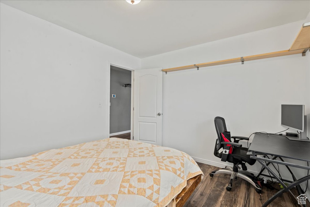 Bedroom with wood finished floors and baseboards