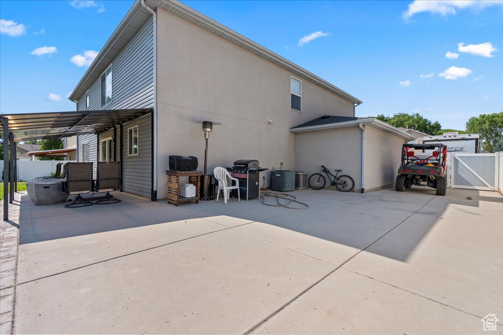 Rear view of property with a patio and a gate