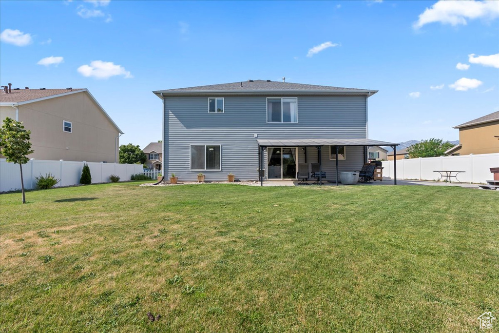 Back of property with a patio area and a fenced backyard