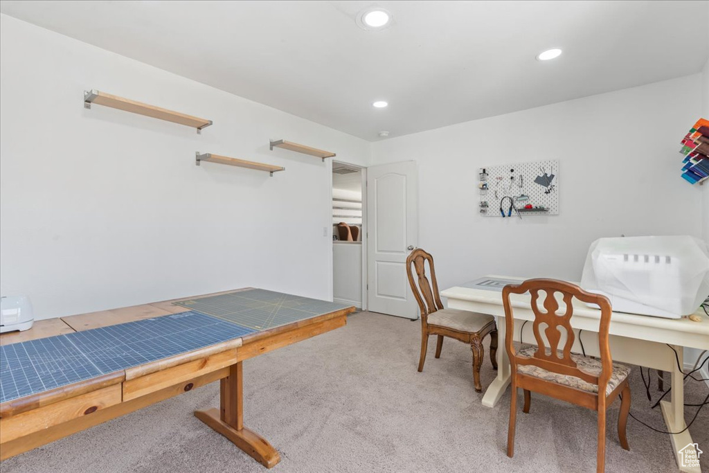 Office area with light carpet and recessed lighting
