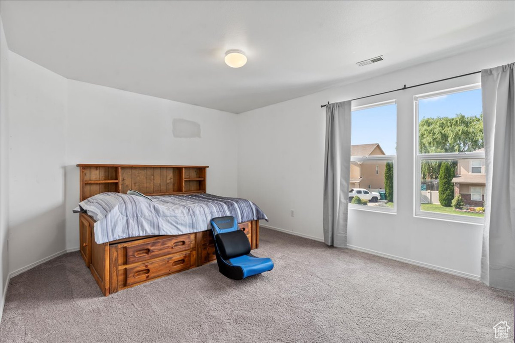 Carpeted bedroom with baseboards