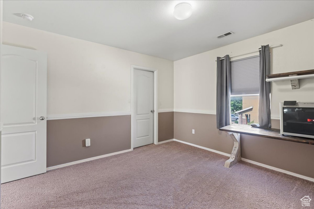 Unfurnished office featuring carpet flooring and baseboards