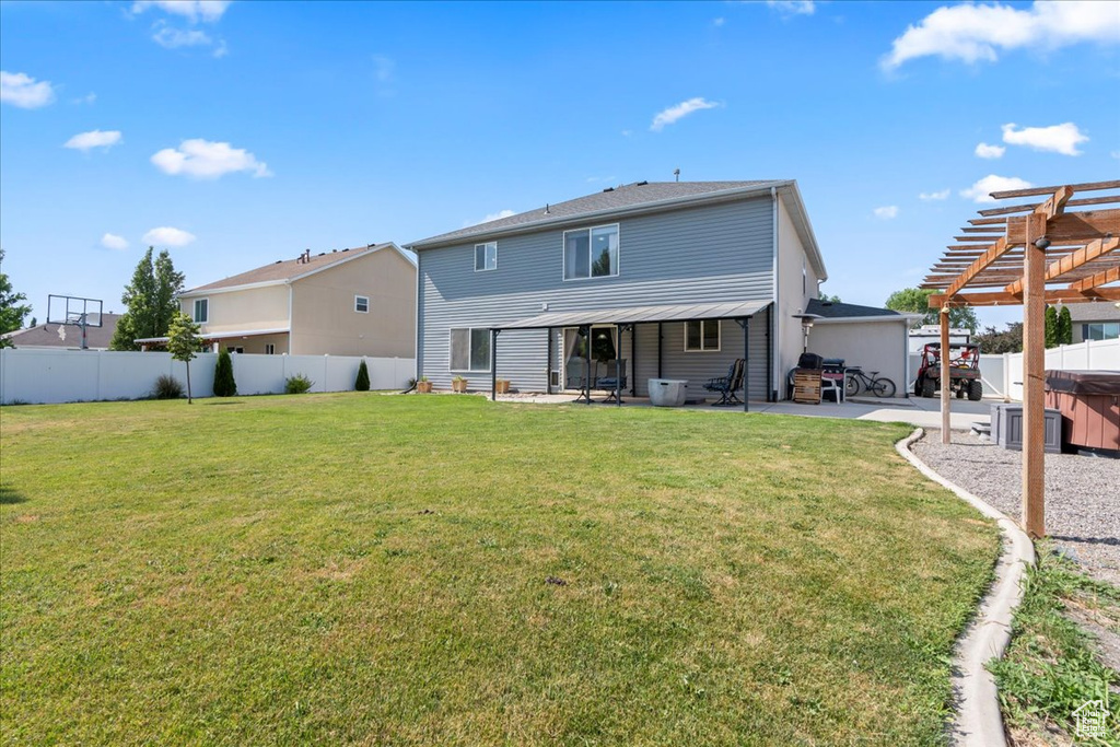 Back of house featuring a pergola, a fenced backyard, and a patio area