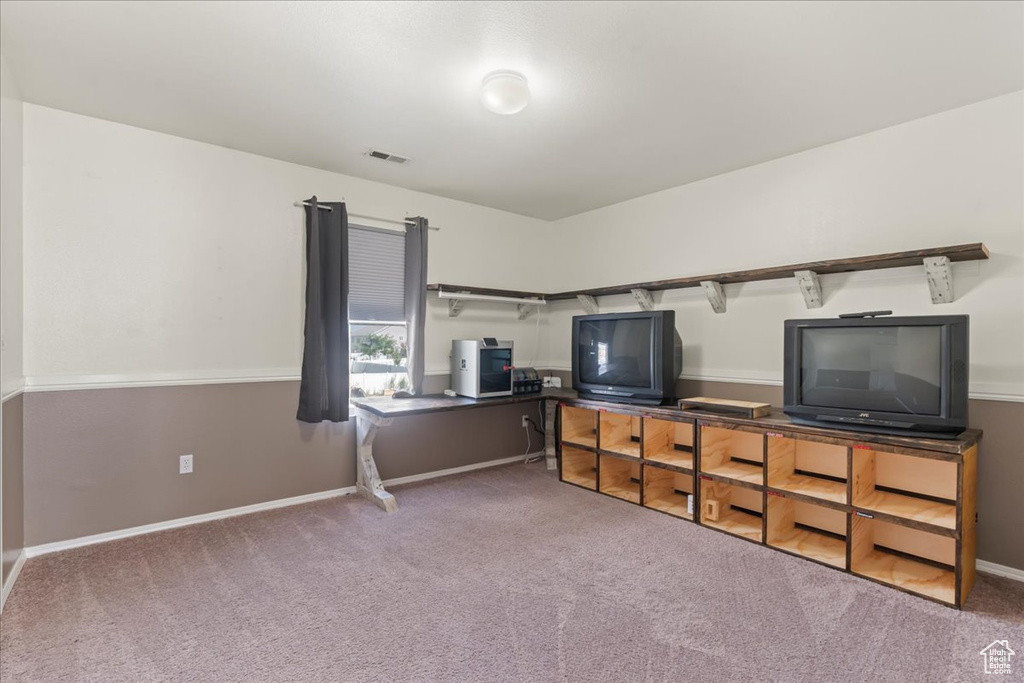 Living area featuring carpet and baseboards
