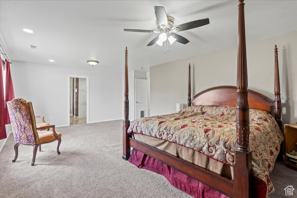 Carpeted bedroom featuring ceiling fan and recessed lighting