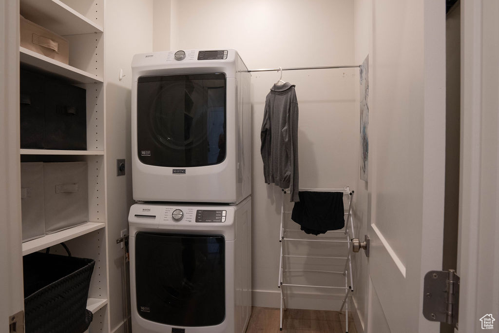 Laundry area with stacked washer and clothes dryer
