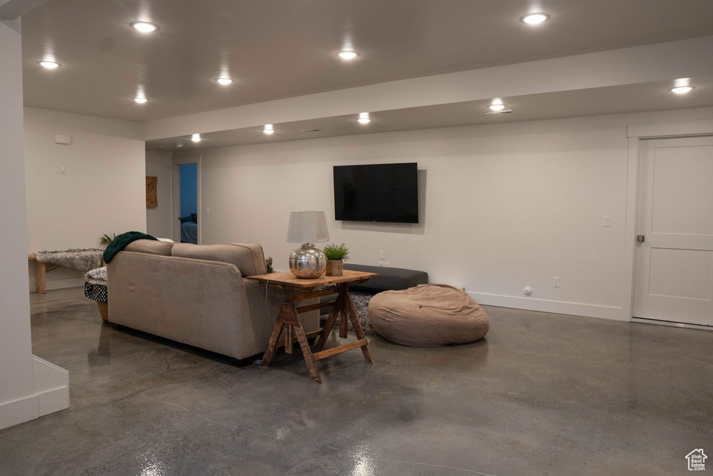 Living area with finished concrete floors and recessed lighting