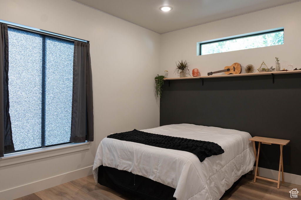 Bedroom featuring wood finished floors and recessed lighting