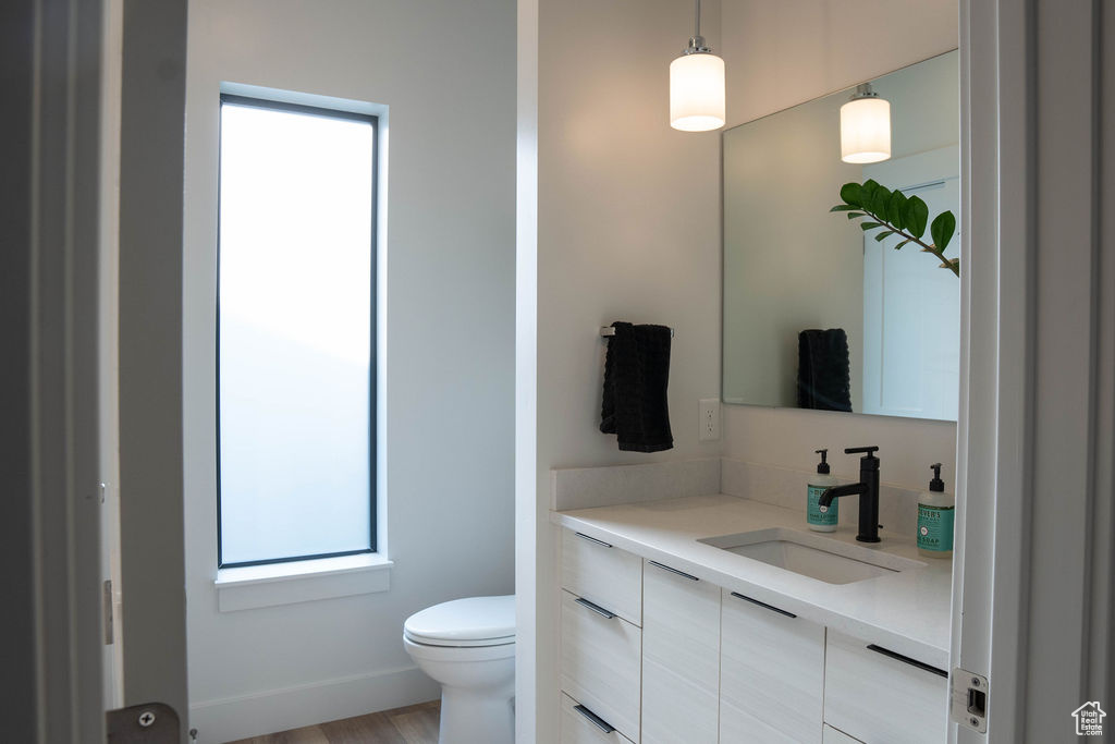 Half bathroom featuring toilet and vanity