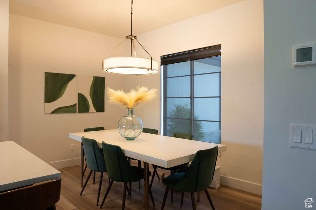 Dining room featuring baseboards and dark wood finished floors