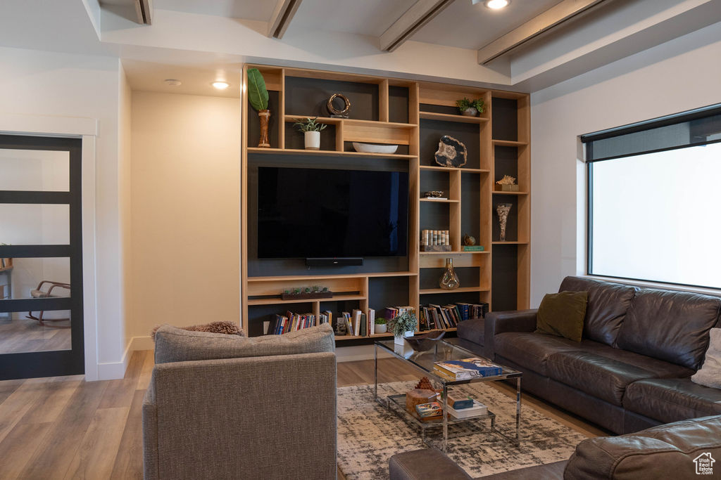 Living room featuring wood finished floors, beamed ceiling, and recessed lighting