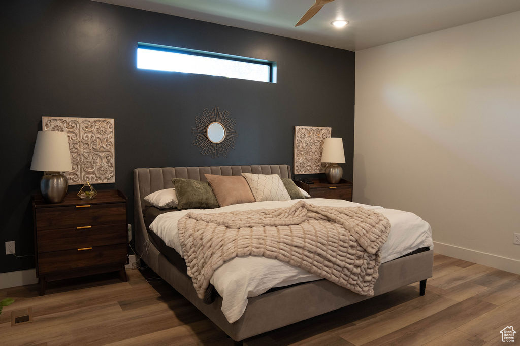 Bedroom with wood finished floors and a ceiling fan