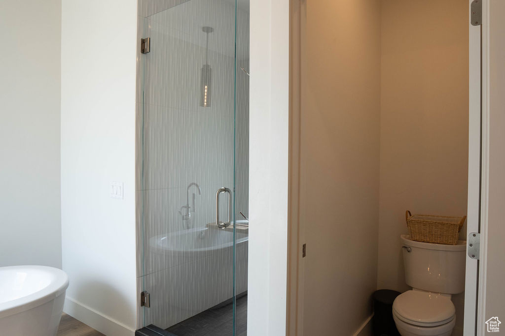Bathroom with a stall shower and toilet