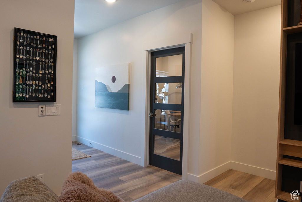 Hall featuring wood finished floors and baseboards