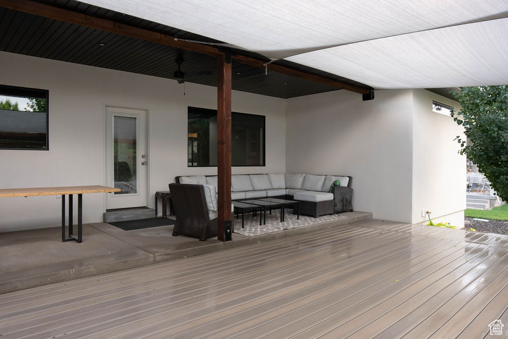 Deck featuring an outdoor living space and ceiling fan