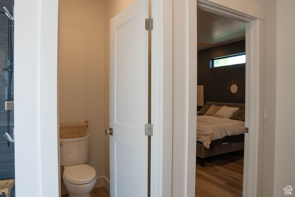 Bathroom featuring wood finished floors and connected bathroom