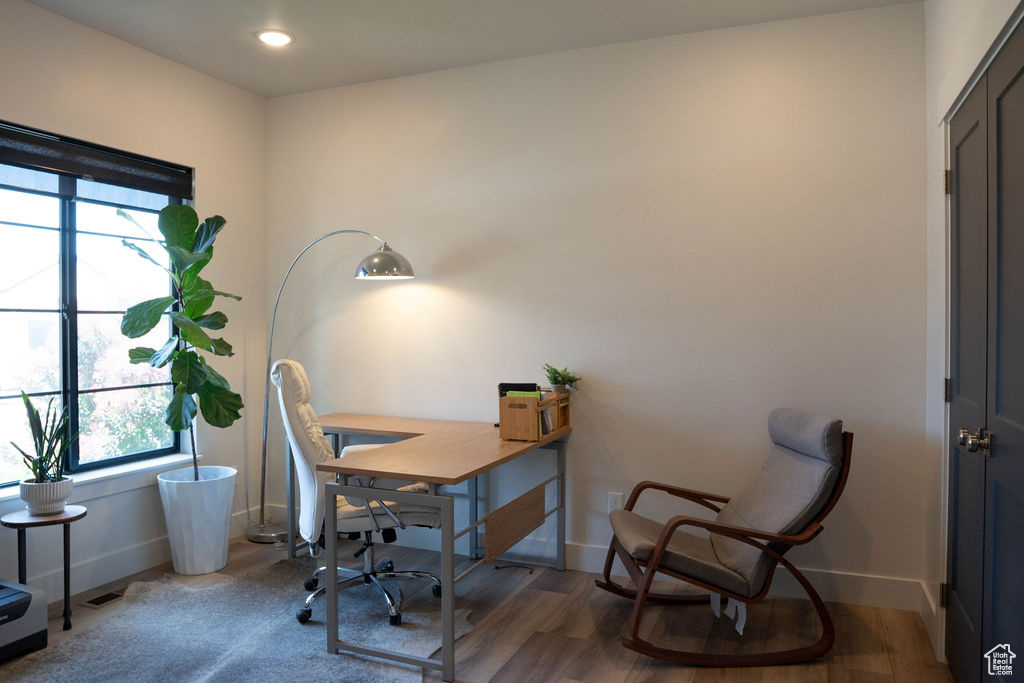 Home office featuring wood finished floors and recessed lighting