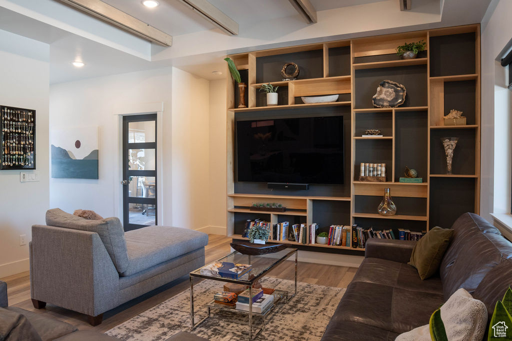 Living area featuring wood finished floors and beamed ceiling