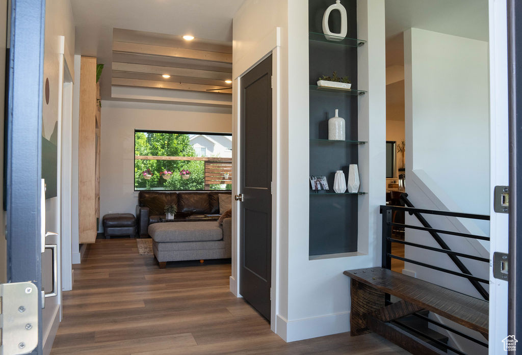 Hall with wood finished floors and recessed lighting