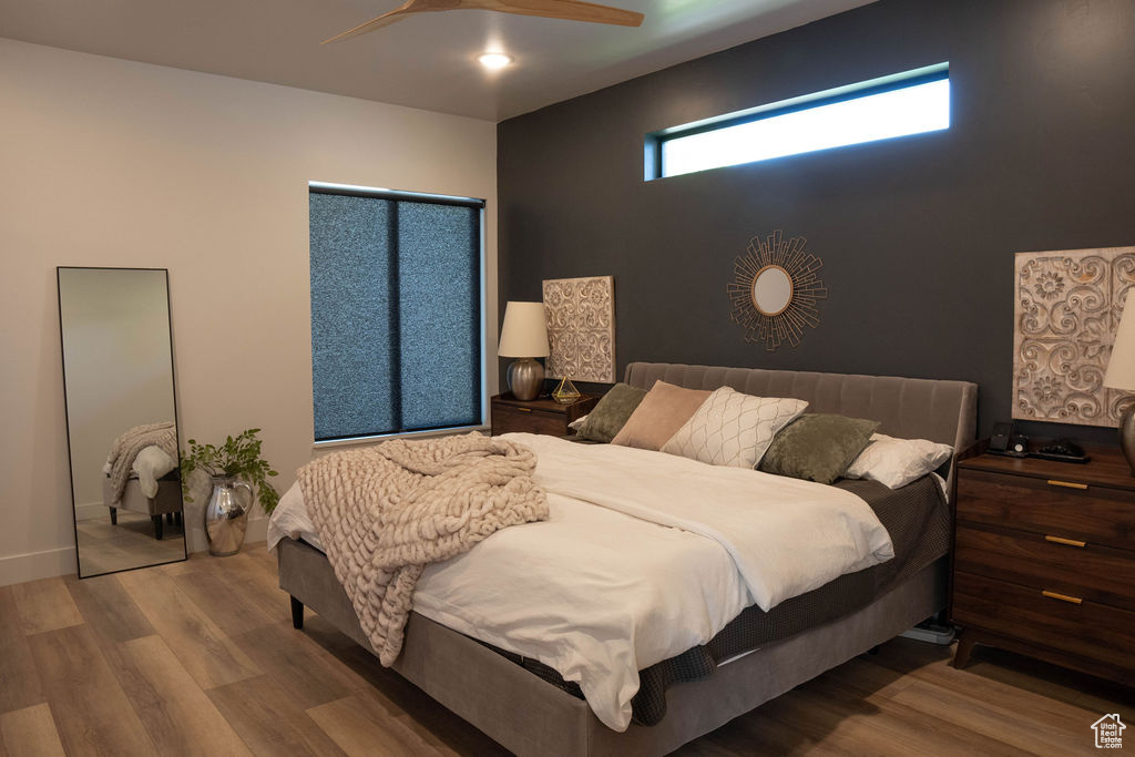 Bedroom featuring wood finished floors and a ceiling fan