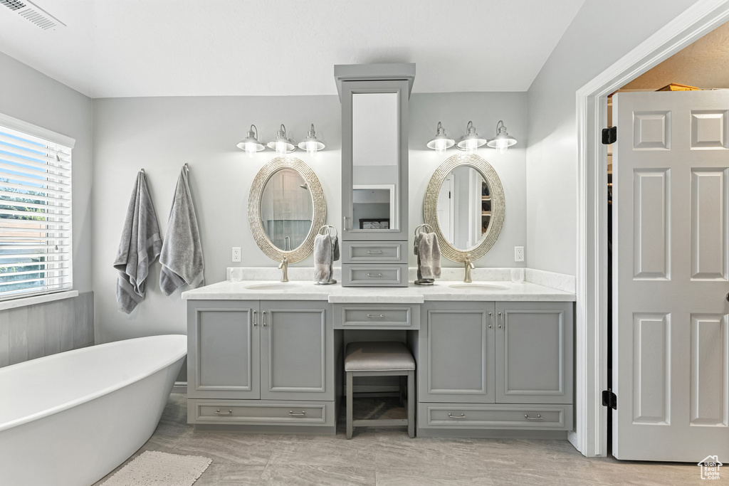 Bathroom with double vanity and a freestanding bath