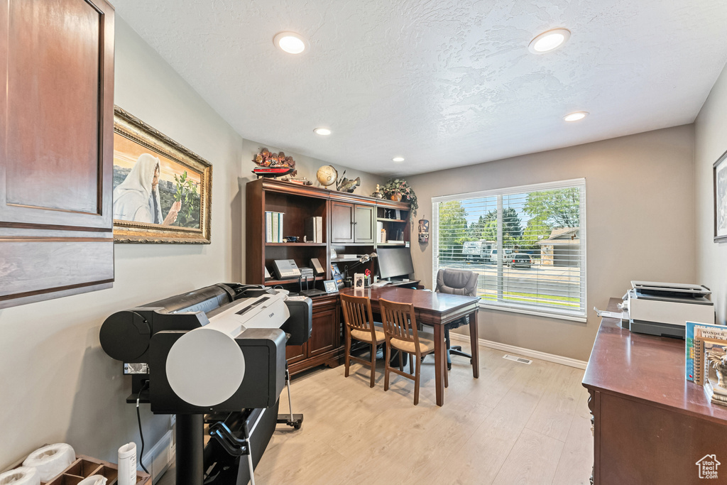 Office featuring light wood-type flooring and recessed lighting