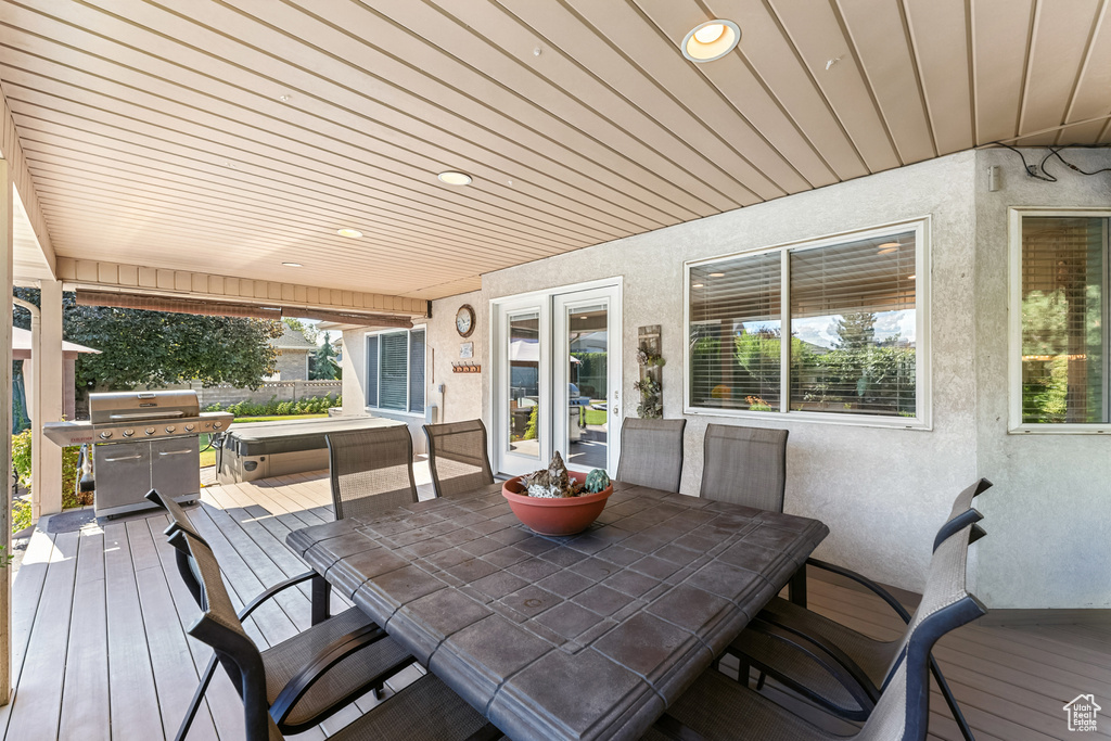 Wooden deck with outdoor dining area and grilling area
