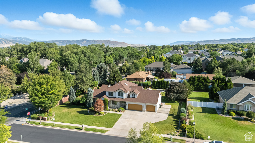 Aerial perspective of suburban area featuring a mountainous background