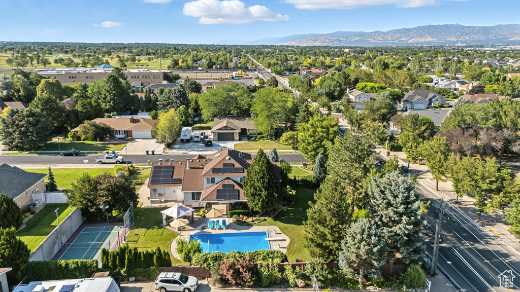 Aerial view of residential area with a pool and a mountain backdrop