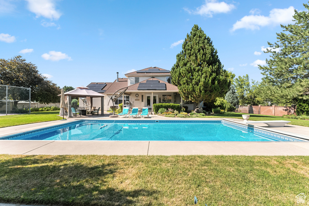 View of pool featuring a gazebo, a patio area, and a diving board
