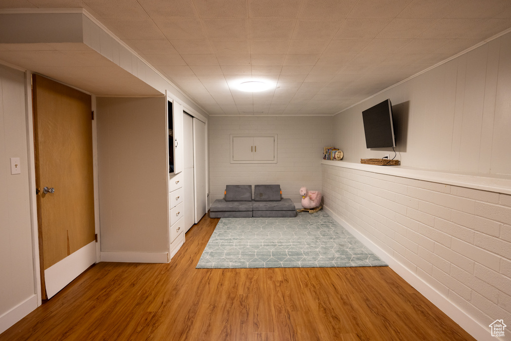 Living area with wood finished floors and crown molding