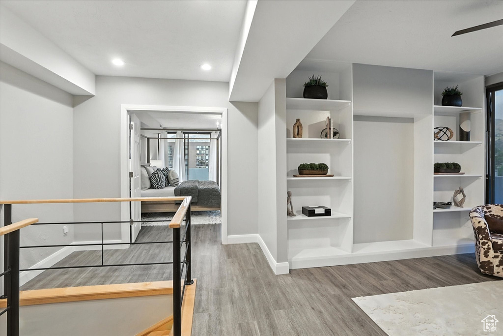 Spacious closet featuring a ceiling fan and wood finished floors