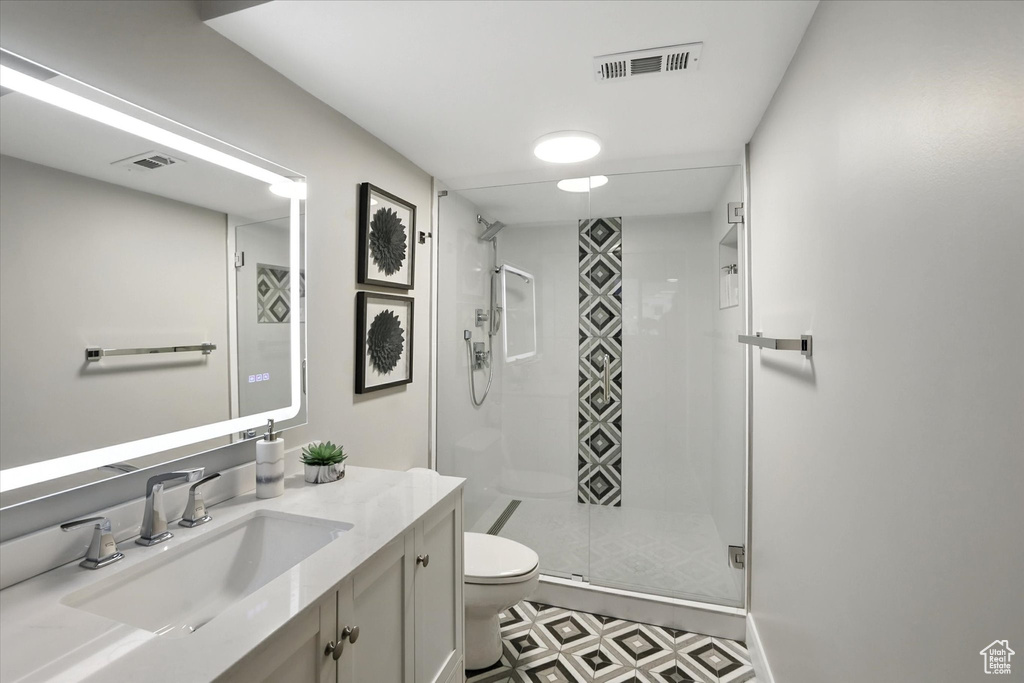 Bathroom featuring vanity, a stall shower, and tile patterned floors