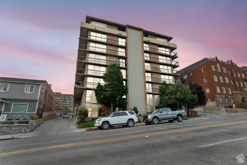 View of property at dusk