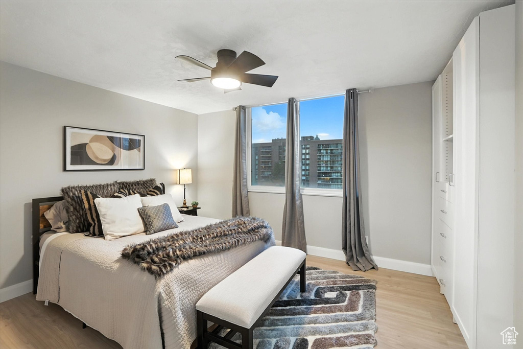 Bedroom with light wood finished floors and ceiling fan
