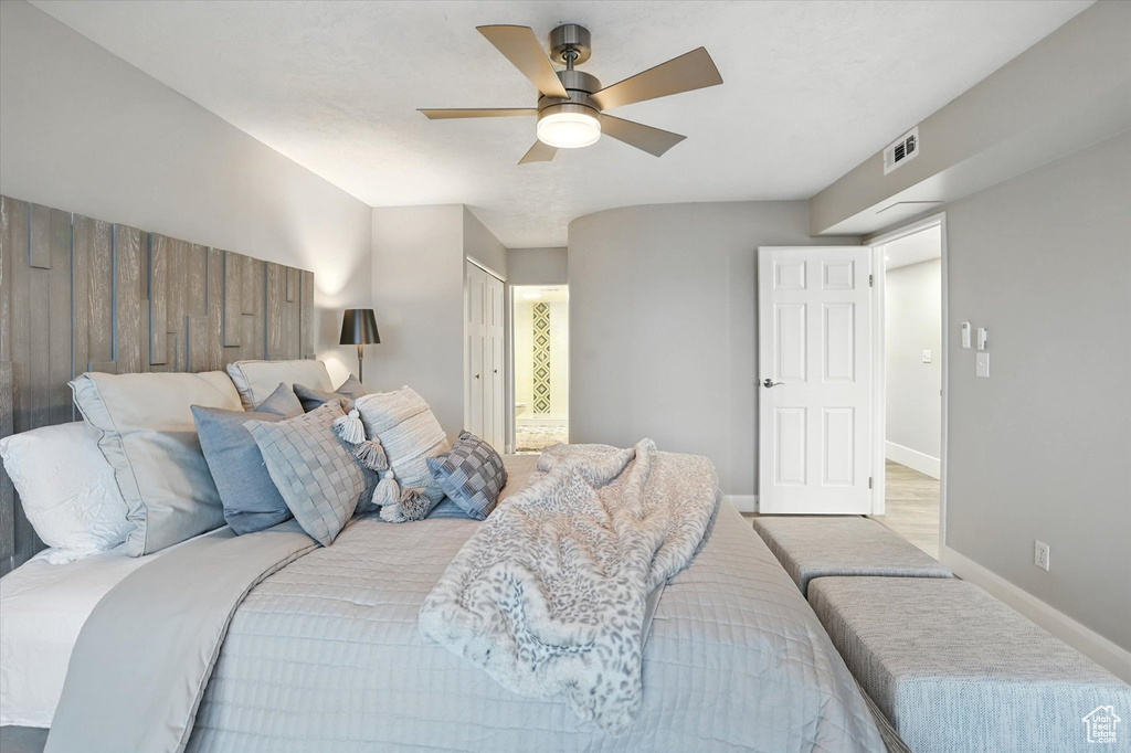 Bedroom with a ceiling fan and baseboards