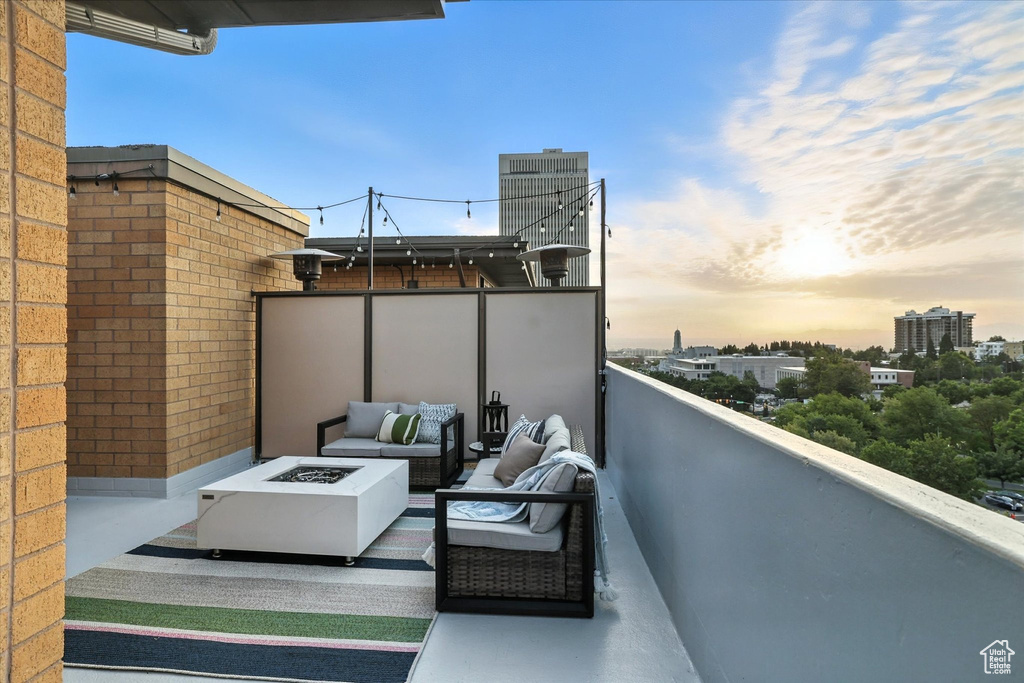 Balcony featuring an outdoor living space with a fire pit