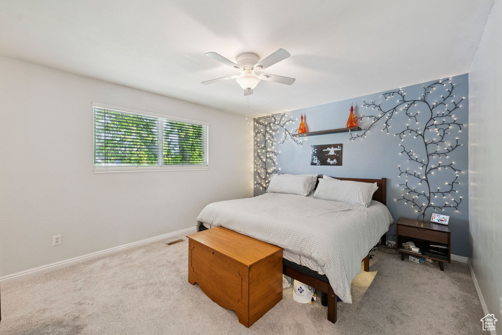 Carpeted bedroom with baseboards and ceiling fan