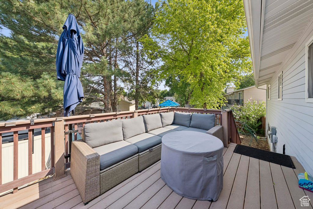 Wooden deck featuring an outdoor living space