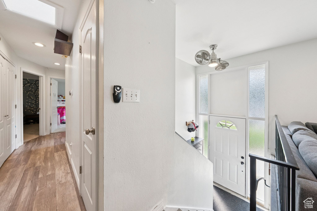 Hall featuring light wood-style floors and recessed lighting