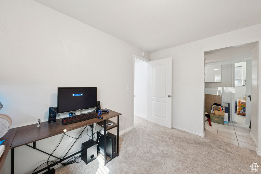 Carpeted office space featuring baseboards