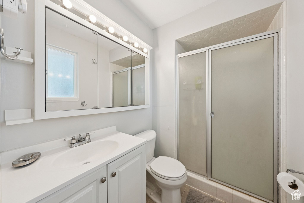 Bathroom with a shower stall and vanity
