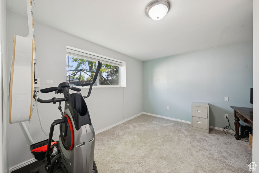 Exercise room with carpet floors and baseboards