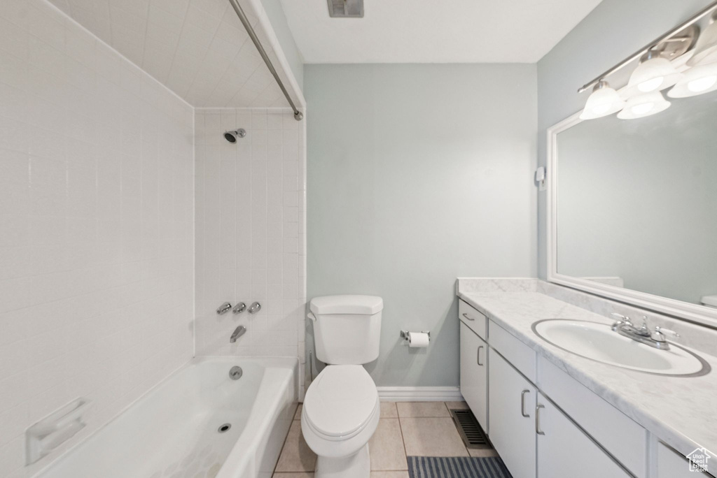 Full bath with vanity, tile patterned floors, and bathtub / shower combination