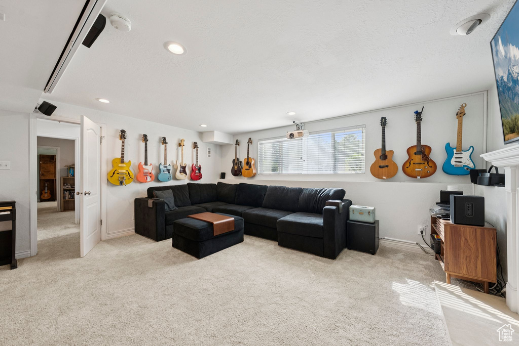 Living area featuring light colored carpet and recessed lighting