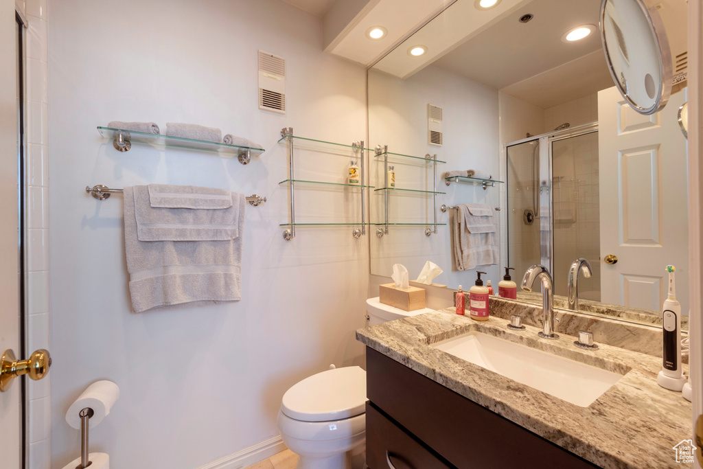 Full bath featuring recessed lighting, vanity, and a shower stall