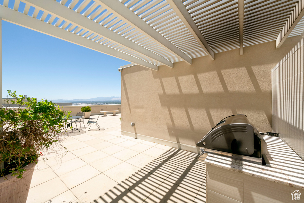 View of patio featuring a pergola, a mountain view, and grilling area
